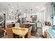 Open kitchen with white cabinets, stainless steel appliances, wine cooler, and adjacent dining area at 2724 Sarzana Ln, Apopka, FL 32712