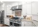 Close-up on a well-equipped kitchen with stainless steel range and custom backsplash at 2724 Sarzana Ln, Apopka, FL 32712