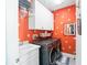 Cozy laundry room with modern washer and dryer, sink, and storage cabinets at 2724 Sarzana Ln, Apopka, FL 32712