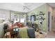 Comfortable living room with a ceiling fan, a mounted TV, and decorative shelves at 2724 Sarzana Ln, Apopka, FL 32712