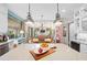Open-concept living space connects the kitchen, dining, and living areas at 2724 Sarzana Ln, Apopka, FL 32712