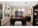 Well-appointed home office with custom built-ins, a large desk, and ample natural light from multiple windows at 2724 Sarzana Ln, Apopka, FL 32712