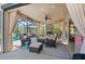 Relaxing screened patio featuring a fireplace, comfortable seating, and view of the pool at 2724 Sarzana Ln, Apopka, FL 32712