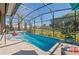 Private screened in pool area with a beautiful backyard view and a pink flamingo at 2724 Sarzana Ln, Apopka, FL 32712