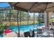 Screened in pool area with outdoor dining and a stunning view of the greenery beyond at 2724 Sarzana Ln, Apopka, FL 32712
