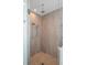 Glass shower featuring pebble flooring, rain shower head, and hand held shower wand at 2724 Sarzana Ln, Apopka, FL 32712