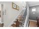 Elegant stairway with wood treads, patterned risers, and decorative iron railing at 2724 Sarzana Ln, Apopka, FL 32712