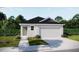 Charming single-story home featuring a two-car garage, a front lawn, and beautiful landscaping at 2735 San Marco Way, Winter Haven, FL 33884