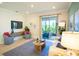 Modern living room with stylish seating, contemporary decor, and sliding glass doors opening to the outdoors at 2735 San Marco Way, Winter Haven, FL 33884