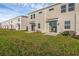 Backyard featuring a well-maintained lawn and sliding glass doors at 2788 Pierr St, Davenport, FL 33837
