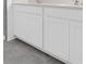 Bathroom vanity featuring double sinks, granite countertop, white cabinetry and tile floors at 2788 Pierr St, Davenport, FL 33837