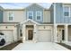 Charming home featuring a light gray and blue exterior, a one-car garage and well-maintained landscaping at 2788 Pierr St, Davenport, FL 33837