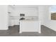 Modern kitchen featuring white cabinets, stainless steel appliances, and a central island at 2788 Pierr St, Davenport, FL 33837