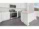 Contemporary kitchen boasting stainless steel appliances, white cabinets, and a stylish island at 2788 Pierr St, Davenport, FL 33837