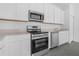 A modern kitchen with stainless steel appliances and white cabinets at 2788 Pierr St, Davenport, FL 33837
