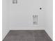 An empty laundry room with gray tile floors at 2788 Pierr St, Davenport, FL 33837