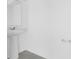 Bright powder room features a white pedestal sink, tile floors, and neutral paint at 2788 Pierr St, Davenport, FL 33837