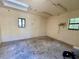 Spacious garage with painted walls and a concrete floor, illuminated by fluorescent lighting and natural light at 285 W 2Nd St, Chuluota, FL 32766