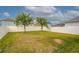 Back yard with grass and white vinyl fence at 3010 Ballad Rd, Kissimmee, FL 34746