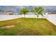 Back yard with a white vinyl fence and landscaping at 3010 Ballad Rd, Kissimmee, FL 34746