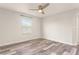 Bedroom featuring wood-look flooring, a ceiling fan, and a bright window at 3010 Ballad Rd, Kissimmee, FL 34746