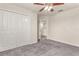 Carpeted bedroom includes a closet and door to an adjacent room, with a fan overhead at 3010 Ballad Rd, Kissimmee, FL 34746
