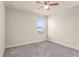 Bedroom with a neutral palette, ceiling fan, gray carpet, and a window allowing natural light at 3010 Ballad Rd, Kissimmee, FL 34746