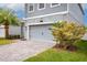 Garage and front yard of a charming home with well-maintained landscaping at 3010 Ballad Rd, Kissimmee, FL 34746