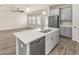 Kitchen island with stainless steel sink, white quartz countertops and seating at 3010 Ballad Rd, Kissimmee, FL 34746