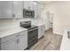 Kitchen with light gray cabinetry, stainless steel appliances, and white countertops at 3010 Ballad Rd, Kissimmee, FL 34746