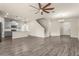 Open-concept living space with modern gray cabinets, stainless steel appliances and tile floors at 3010 Ballad Rd, Kissimmee, FL 34746