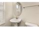 Powder room with pedestal sink, decorative mirror, and window at 3010 Ballad Rd, Kissimmee, FL 34746