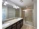 Bathroom featuring double sink vanity, walk-in shower and modern fixtures at 3020 Alessa Loop, Apopka, FL 32703