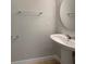 Half bathroom featuring pedestal sink, round mirror, and towel racks at 3020 Alessa Loop, Apopka, FL 32703