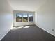 Bright bedroom showcasing large windows and plush carpeting at 3020 Alessa Loop, Apopka, FL 32703