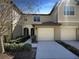 Townhome boasts a well-maintained exterior and attached garages at 3020 Alessa Loop, Apopka, FL 32703