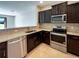 Modern kitchen features granite countertops and stainless steel appliances at 3020 Alessa Loop, Apopka, FL 32703
