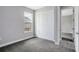 Comfortable carpeted bedroom with a double door closet and a view to the outside at 30340 W Bluebell Ave, Eustis, FL 32736