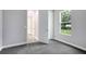 Carpeted bedroom featuring a small window, closet, and access to a hallway at 30340 W Bluebell Ave, Eustis, FL 32736