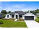 Charming single-story home featuring manicured lawn and modern architectural details at 30340 W Bluebell Ave, Eustis, FL 32736
