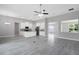Open-concept living space with sleek flooring connecting the kitchen and living areas at 30340 W Bluebell Ave, Eustis, FL 32736