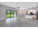 Bright and airy living area with access to the outdoors and a modern kitchen at 30340 W Bluebell Ave, Eustis, FL 32736