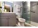 Modern bathroom with gray vanity, white toilet, and a glass-enclosed shower with gray subway tile at 358 Douglas Way # 78, Winter Garden, FL 34787