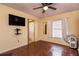 Bedroom with parquet floors, ceiling fan, and view into the bathroom with a shower at 358 Douglas Way # 78, Winter Garden, FL 34787