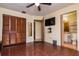 Bedroom with wood floors, ceiling fan, closet, and a view into the bathroom at 358 Douglas Way # 78, Winter Garden, FL 34787