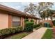 Lovely home exterior highlighting mature trees, green bins, and a walkway at 358 Douglas Way # 78, Winter Garden, FL 34787