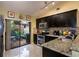Well-equipped kitchen featuring granite countertops and access to outdoor patio at 358 Douglas Way # 78, Winter Garden, FL 34787