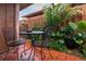 Enclosed patio with tile flooring, a metal bistro set, and lush tropical landscaping at 358 Douglas Way # 78, Winter Garden, FL 34787