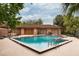 Community pool with a modern bath house, lounge chairs, and a fenced perimeter at 358 Douglas Way # 78, Winter Garden, FL 34787