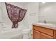 Well-lit bathroom with a shower-tub combo, a floral shower curtain and vanity at 381 Corbett Dr, The Villages, FL 32162